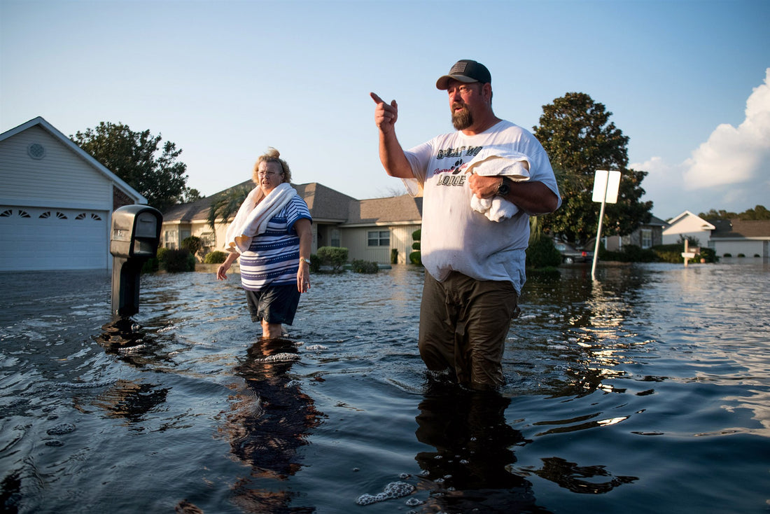 Richard Brown and Janet Hardee walk down a flooded street caused by Hurricane Florence at Aberdeen Country Club on Sept. 20, 2018 in Longs, South Carolina.Sean Rayford / Getty Images file